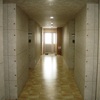 2F社員寮共用廊下　天井・壁はコンクリート打ちっ放し風、床は石調の長尺シート